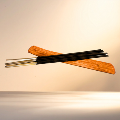 Incense sticks with wooden holder on a beige background