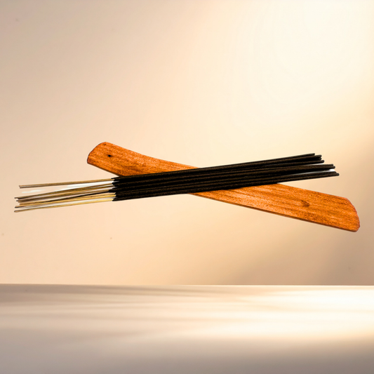 Incense sticks with wooden holder on a beige background