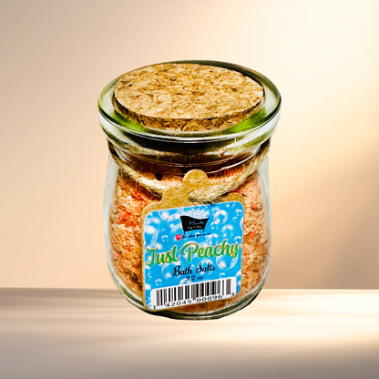 Jar of 'Just Peachy' bath salts with a cork lid on a gradient background