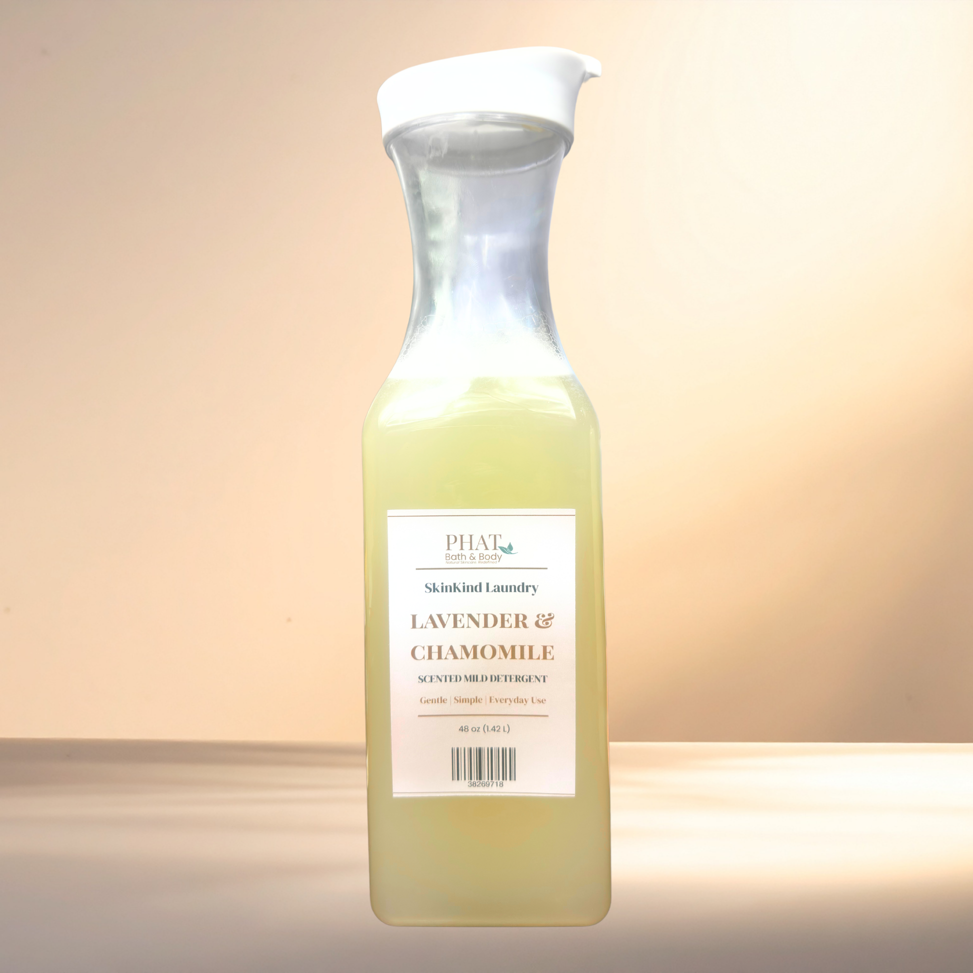 Bottle of lavender and chamomile scented laundry detergent on a gradient background