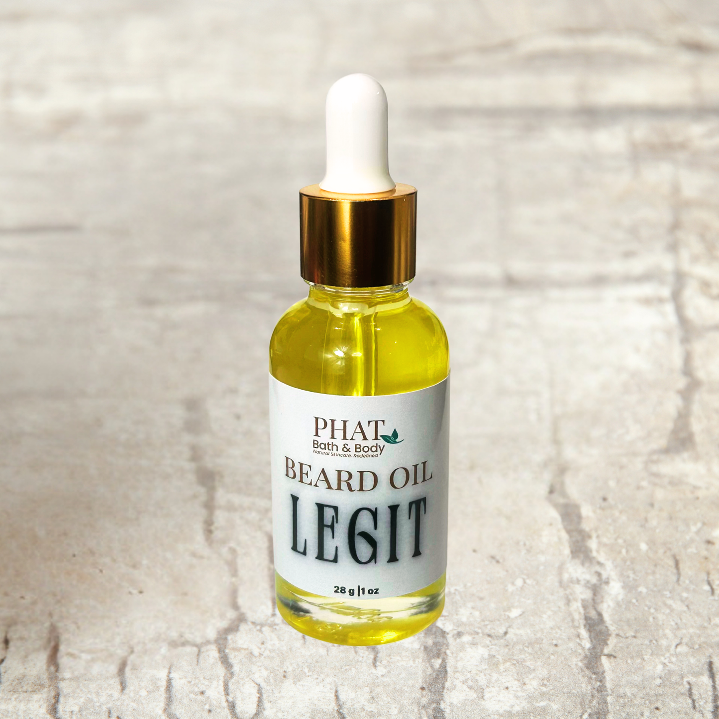Bottle of Phat Bath & Body Beard Oil on a textured surface