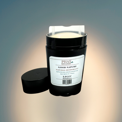 A black cylindrical natural deodorant stick with its cap off and placed beside it on a soft gradient background. The product label reads Legit GOOD NATURE Natural Deodorant.
