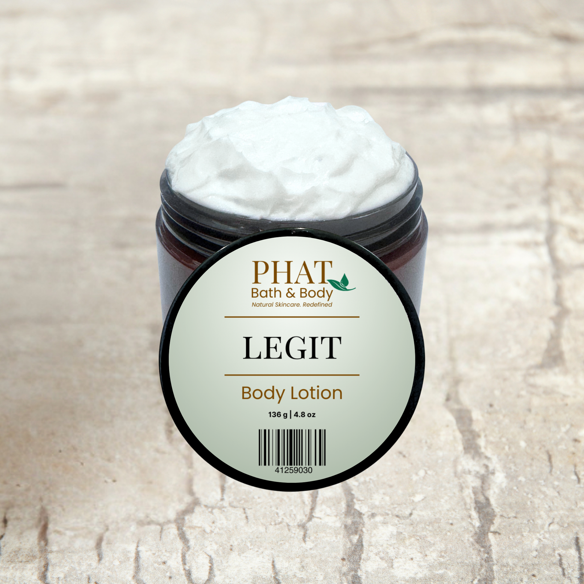 Body lotion container with 'Phat Bath & Body' label on a textured beige background