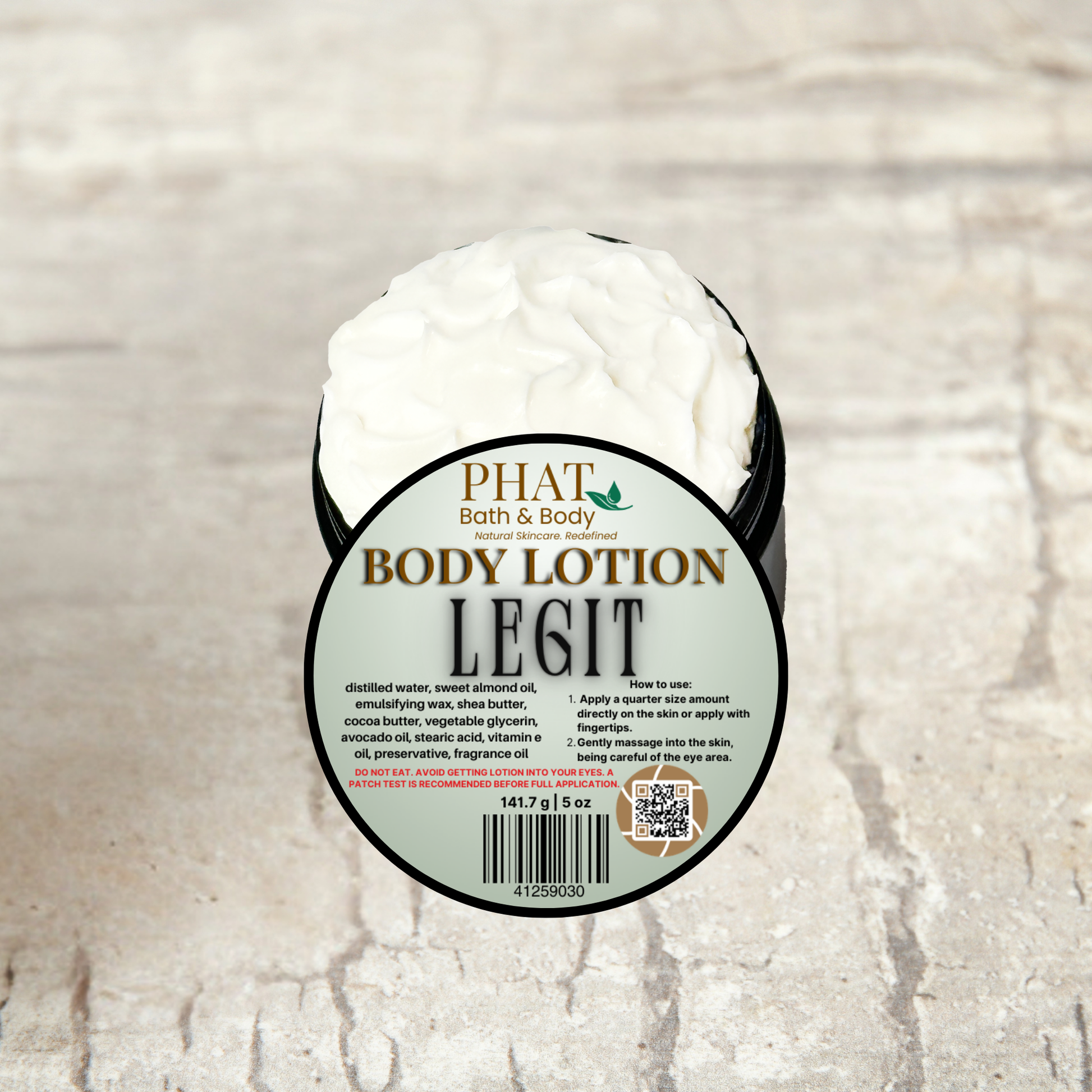 Body lotion container labeled 'PHAT Bath & Body Body Lotion Legit' on a textured beige background