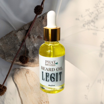 Bottle of Phat Bath & Body beard oil with a dropper on a textured surface.