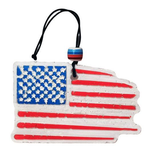 American flag-shaped car freshie with a black string on a white background