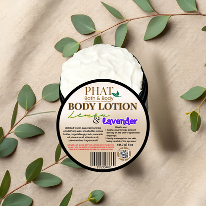 Body lotion container with 'Phat Bath & Body' label on a beige fabric background with green leaves.