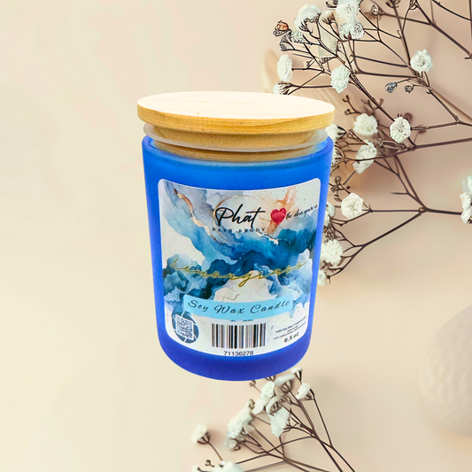 Blue candle with a wooden lid on a beige background with white flowers.