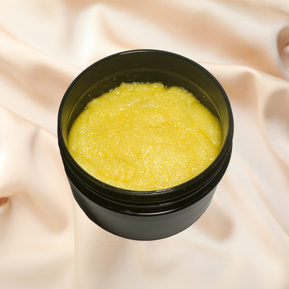 Black container with yellow scrub on a beige fabric background