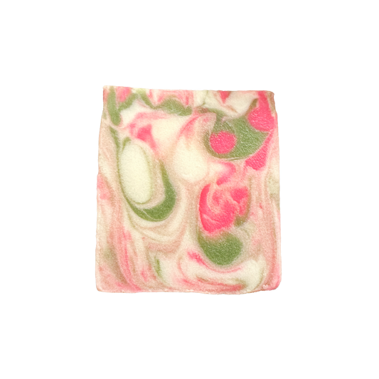 Swirled soap bar with pink and green colors on a white background