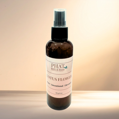 Bottle of PHAT Bath & Body Lotus Flower spray on a gradient background
