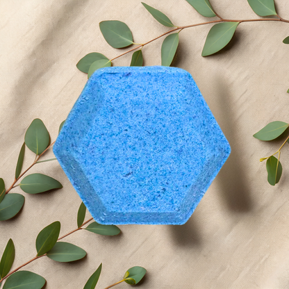 Hexagonal blue steamers with green leaves on a beige fabric background