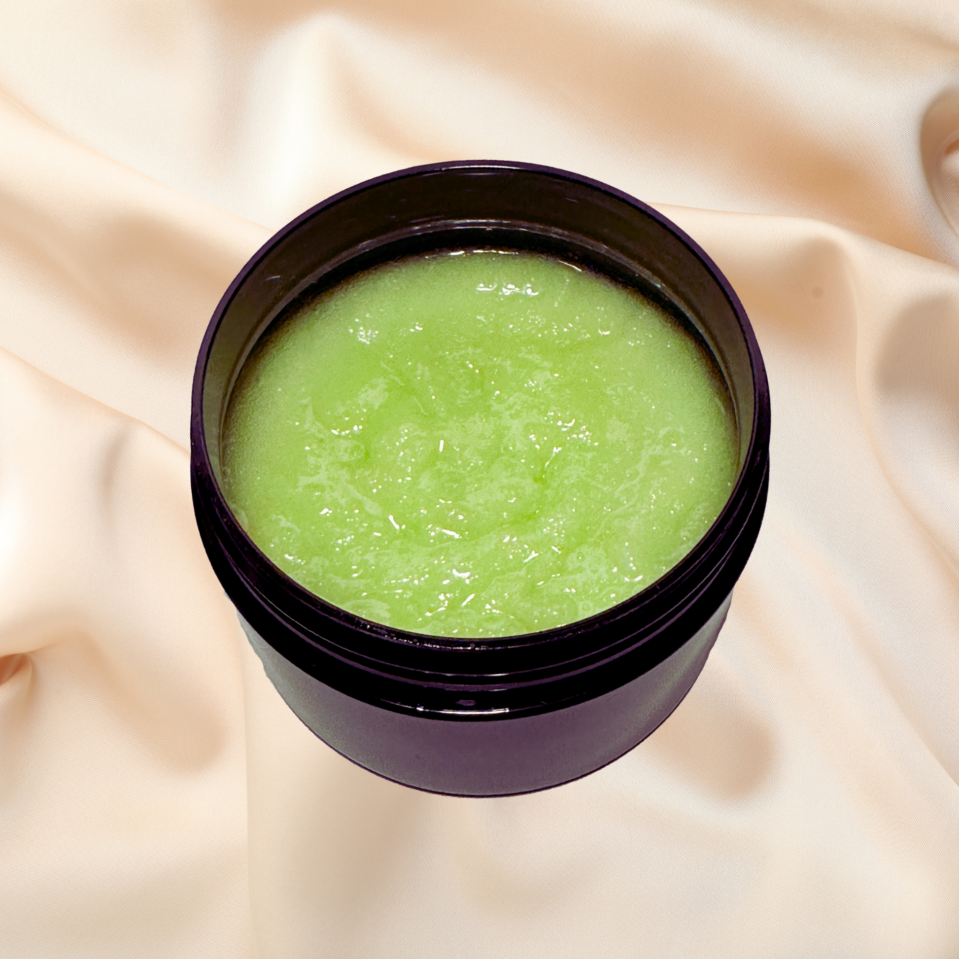 Jar of green scrub on a beige fabric background