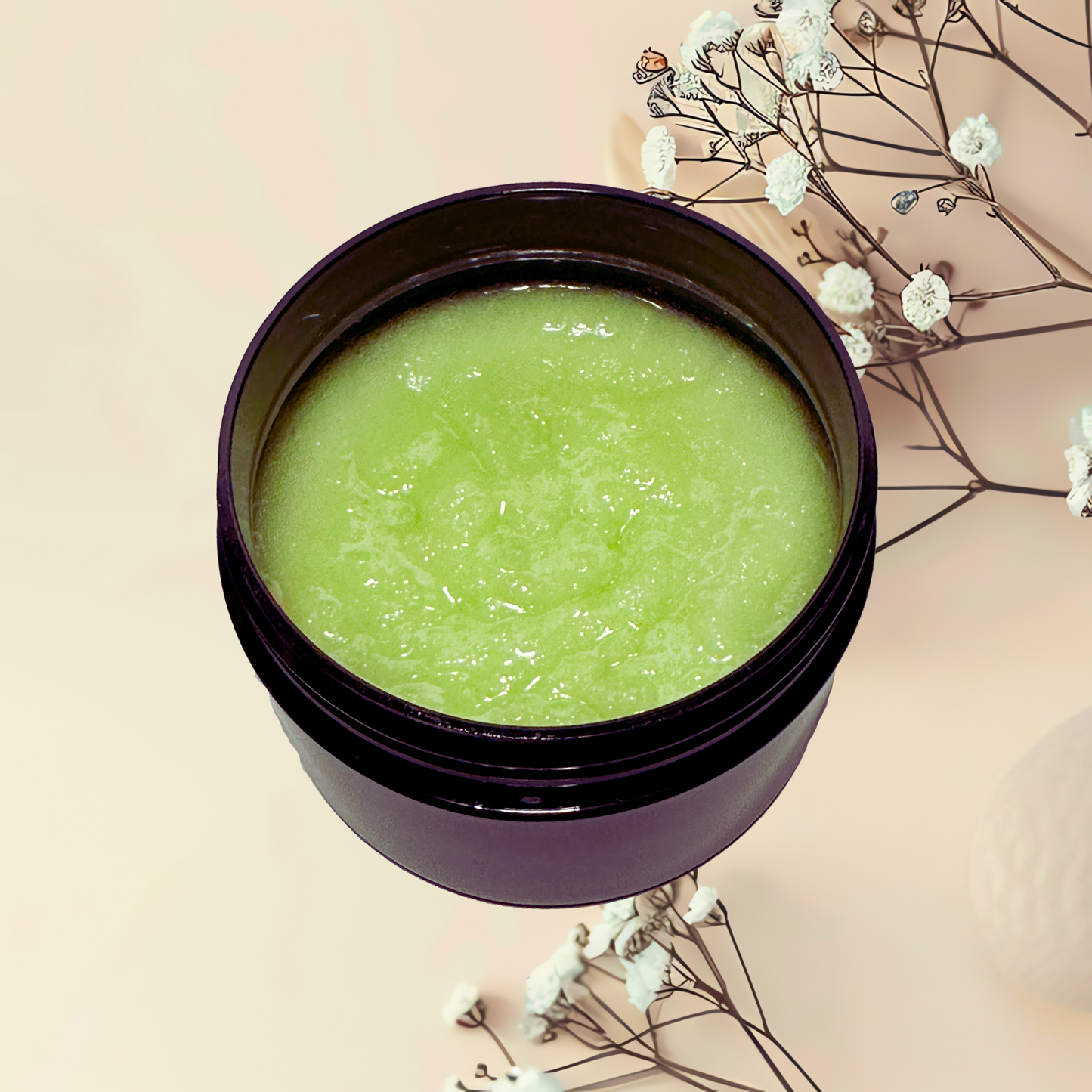 Green scrub in a purple jar with white flowers on a beige background