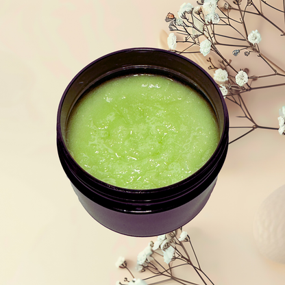 Green scrub in a purple jar with white flowers on a beige background