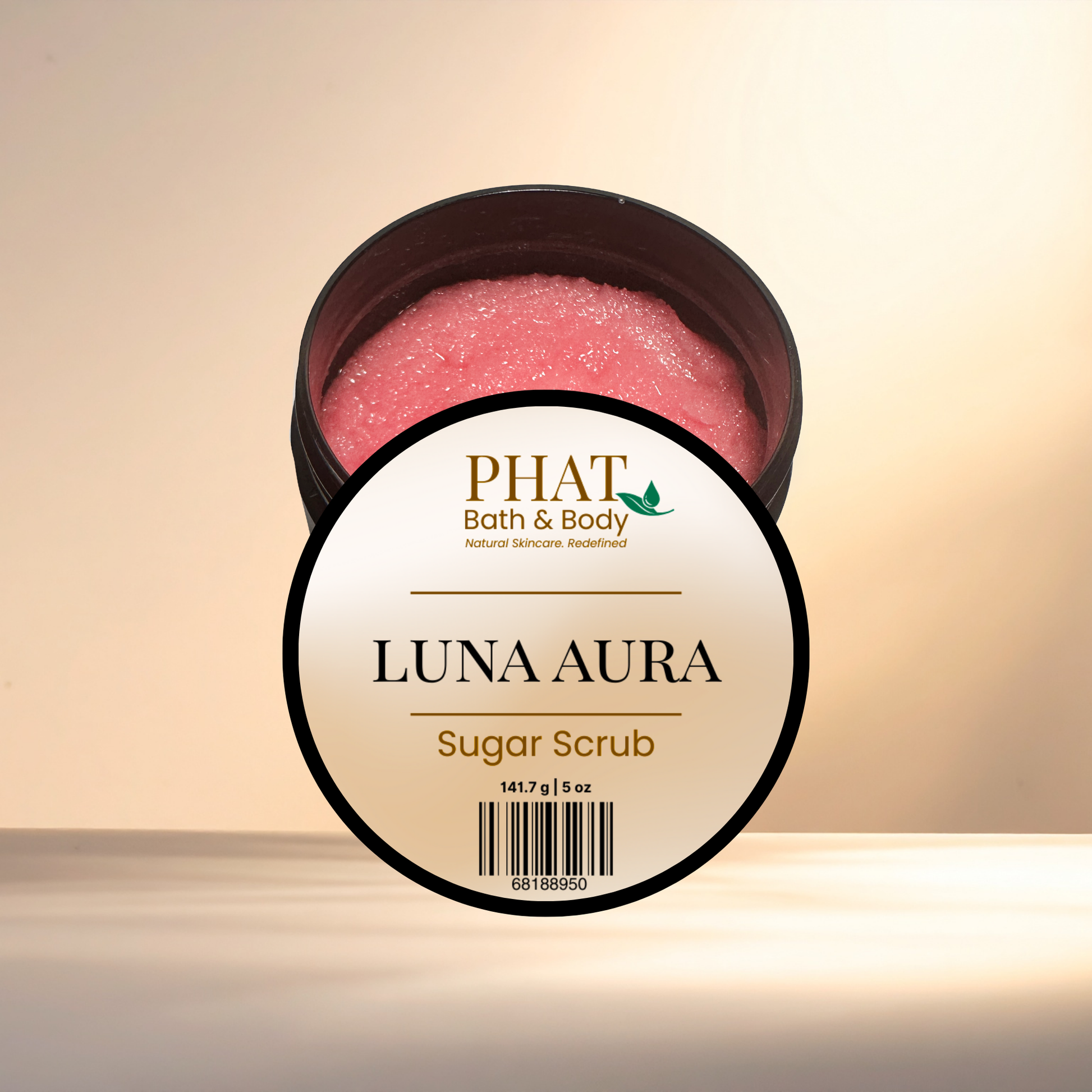 Jar of Luna Aura sugar scrub with 'Phat Bath & Body' label on a beige background