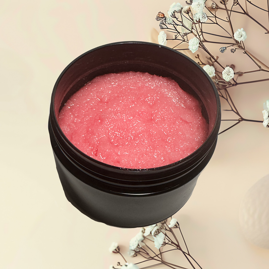Black container with pink scrub on a beige background with white flowers