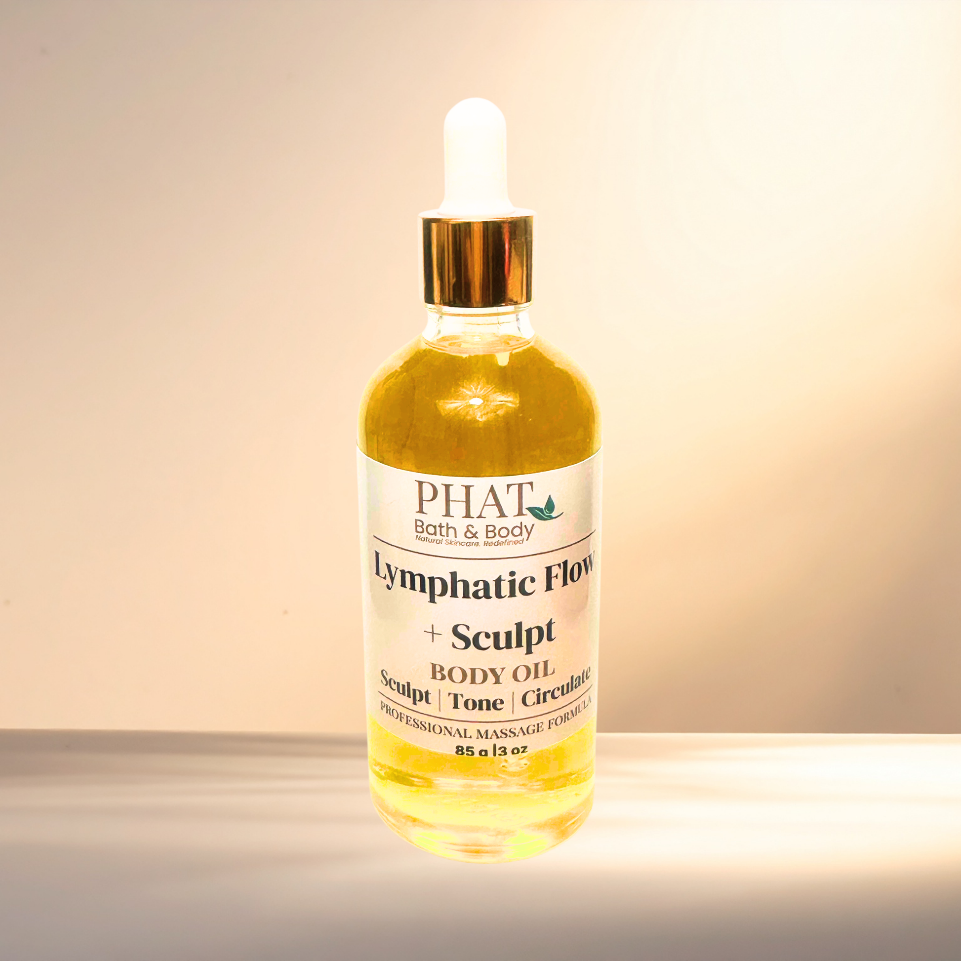 Bottle of PHAT Lymphatic Flow + Sculpt Body Oil on a gradient background