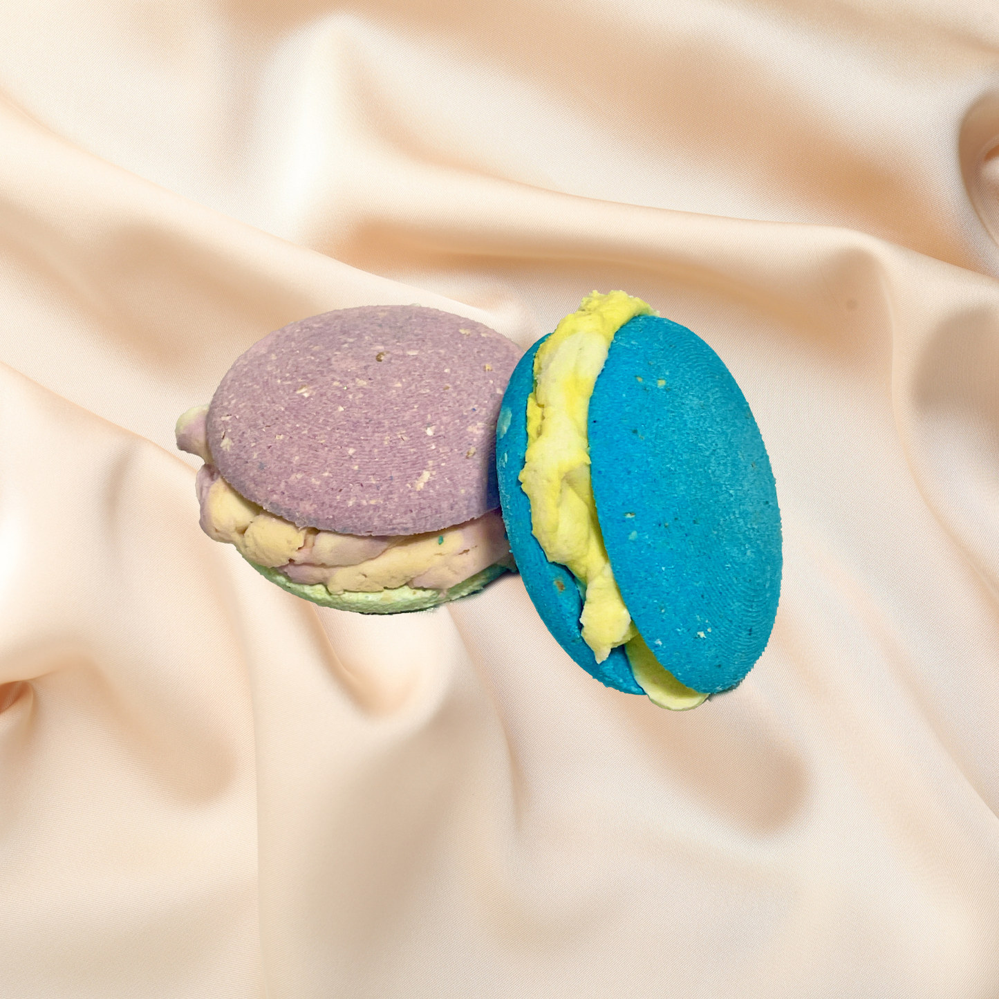 Two colorful bubble bombs on a beige fabric background