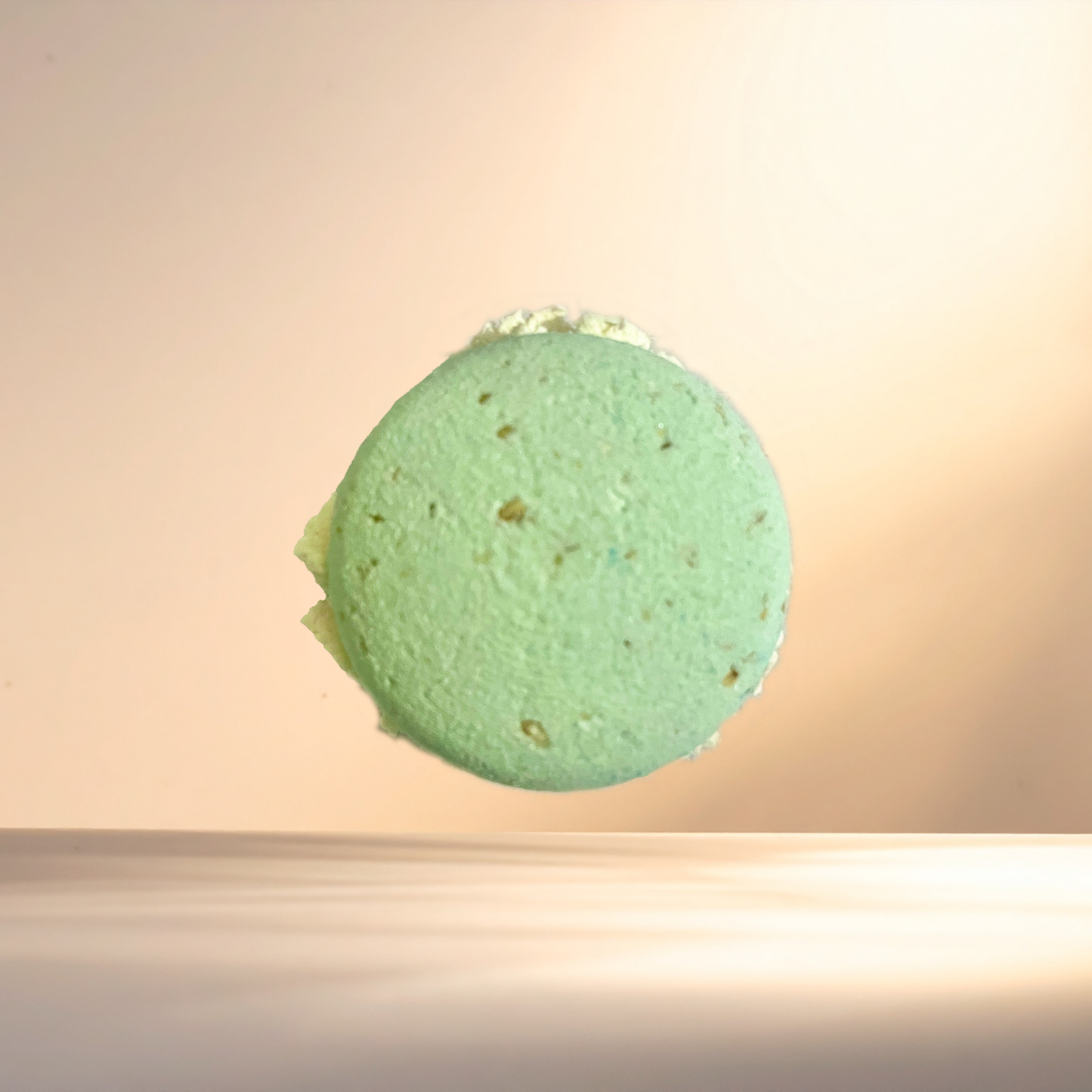 Green bubble bomb on a gradient beige background