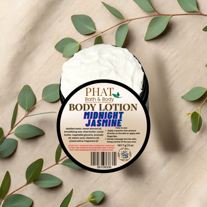 Body lotion container labeled 'PHAT Bath & Body Midnight Jasmine' on a beige fabric background with green leaves.