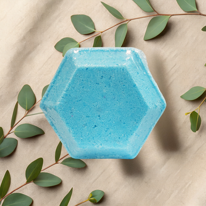 Hexagonal blue steamer on a beige fabric background with green leaves