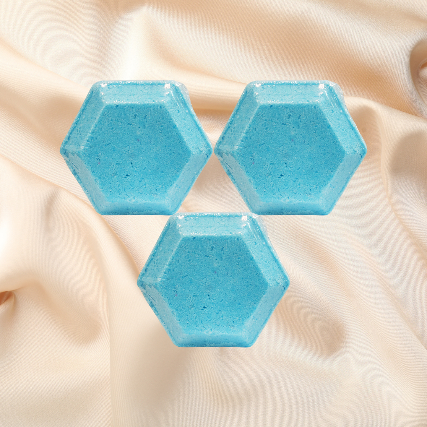 Three hexagonal blue steamers on a beige fabric background