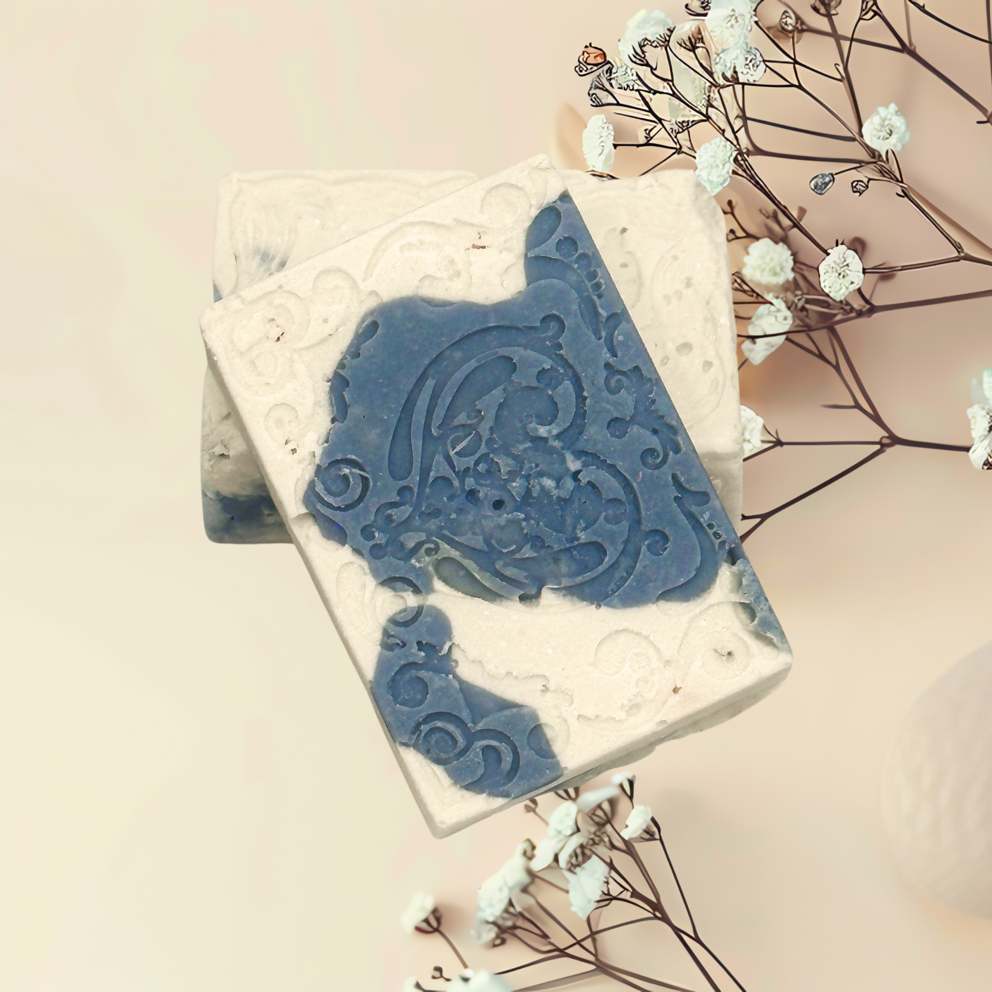 Decorative soap with blue design on a white background with flowers