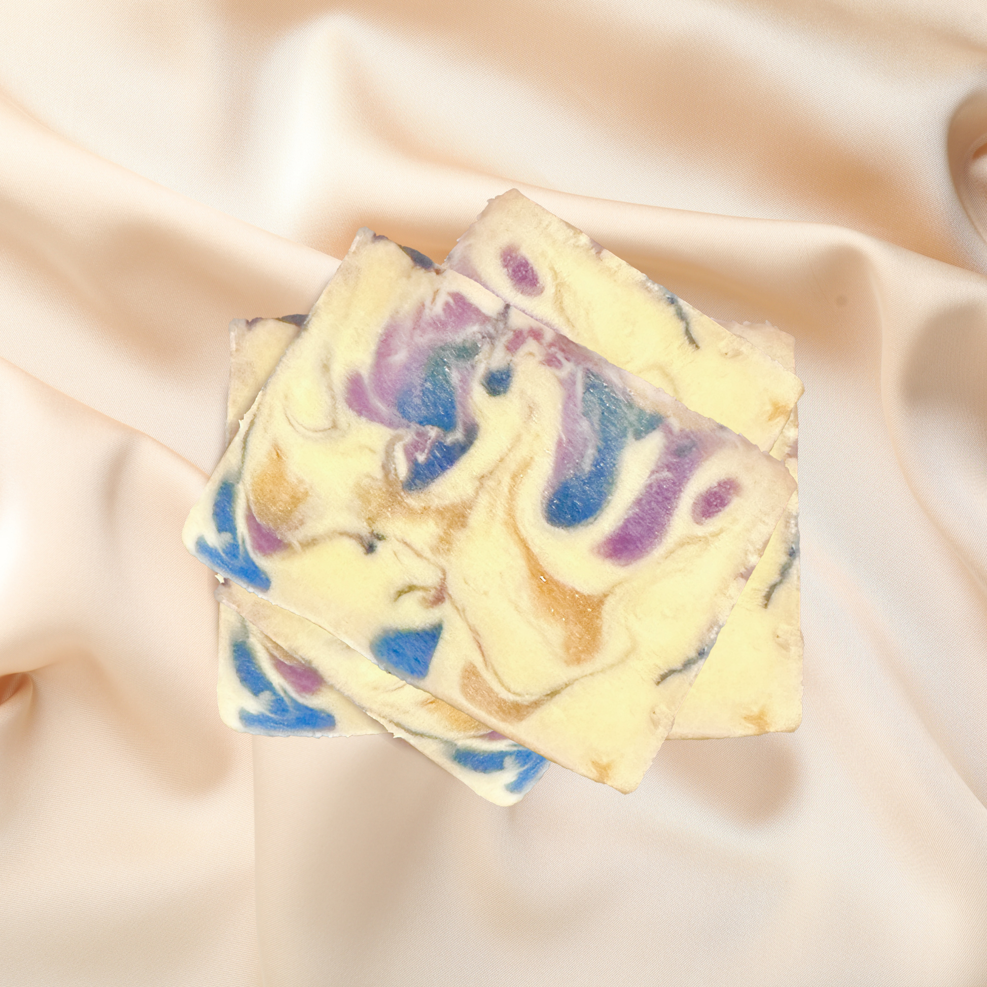 Colorful soap bars with swirl patterns on a soft fabric background
