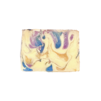 Swirled soap bar with purple, blue, and beige colors on a white background
