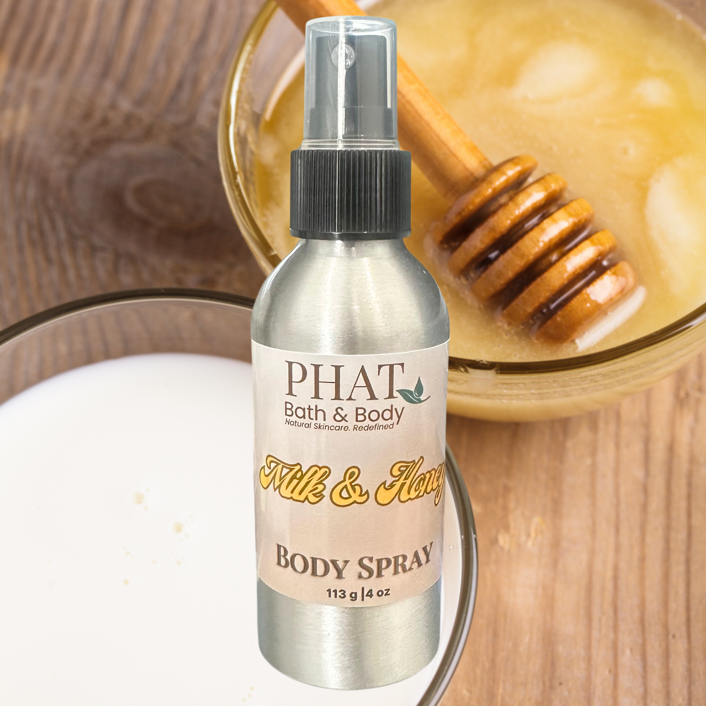 PHAT Bath & Body body spray bottle with a honeycomb and glass of honey in the background