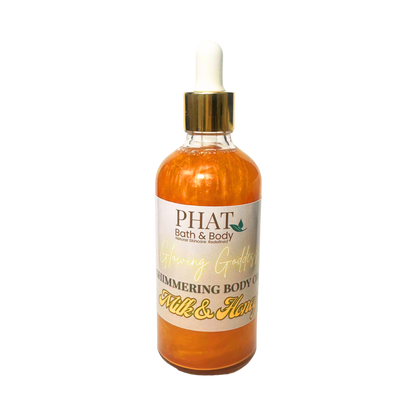 Bottle of 'Milk & Honey' shimmering body oil from Phat Bath & Body on a white background