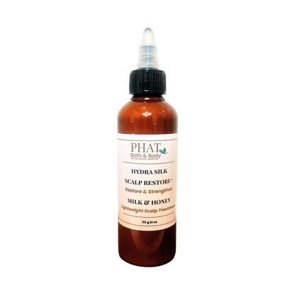 An amber bottle of PHAT Both & Body Hydra silk Scalp Restore Milk & Honey scalp treatment with a black twist cap, centered on a plain white background.