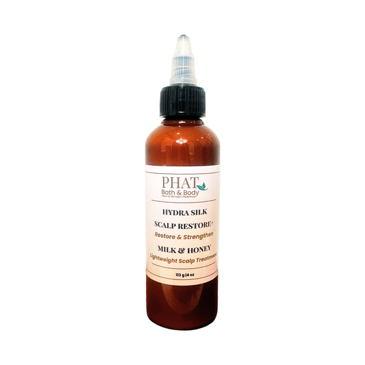 An amber bottle of PHAT Both & Body Hydra silk Scalp Restore Milk & Honey scalp treatment with a black twist cap, centered on a plain white background.