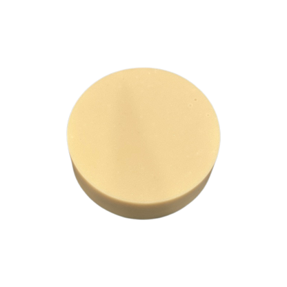 Round beige soap on a white background