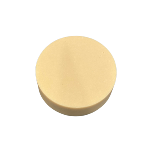 Round beige soap on a white background