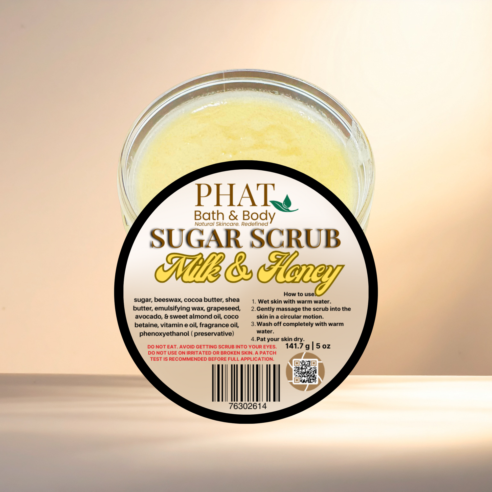 Jar of Phat Bath & Body Sugar Scrub with 'Milk & Honey' label on a beige background