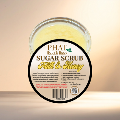 Jar of Phat Bath & Body Sugar Scrub with 'Milk & Honey' label on a beige background