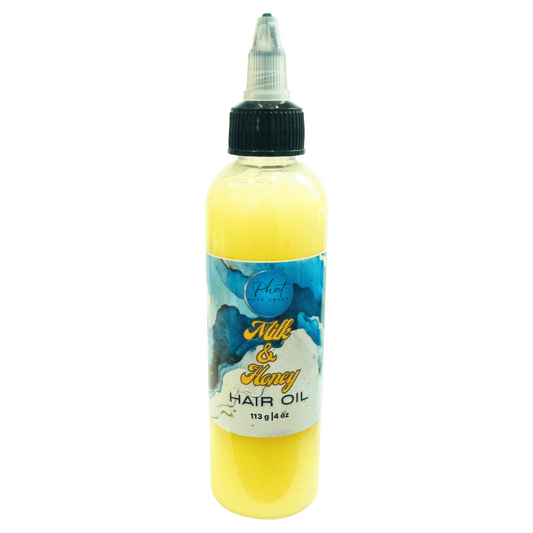 Bottle of Milk & Honey hair growth oil on a white background