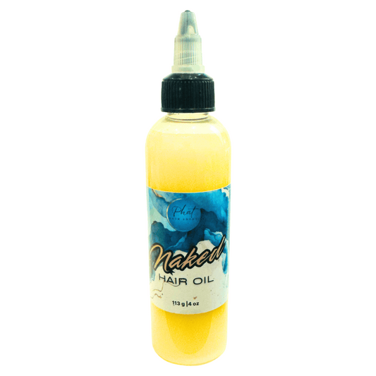 Bottle of Naked hair growth oil on a white background