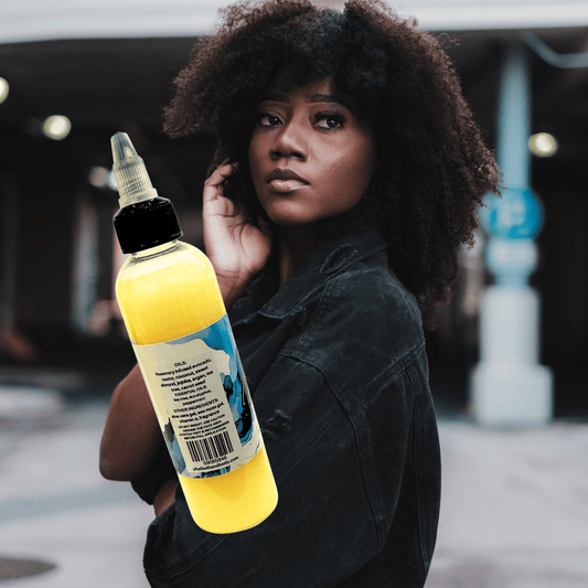 Woman holding a hair growth oil bottle with a ingredients label outdoors