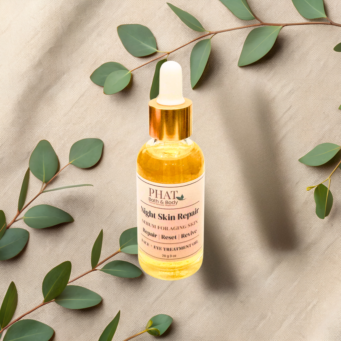 Skincare serum bottle labeled 'PHAT Bath & Body' on a beige fabric background with green leaves.