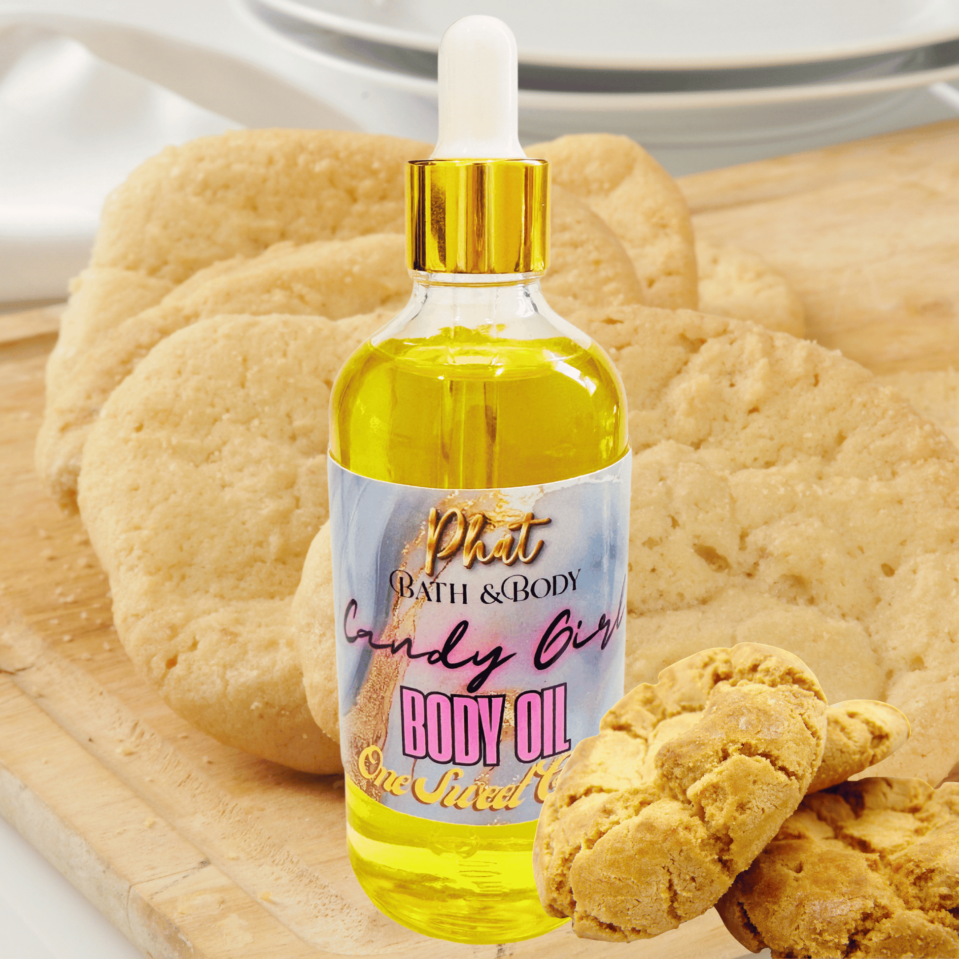 Body oil bottle with a gold cap and colorful label on a wooden surface with cookies.