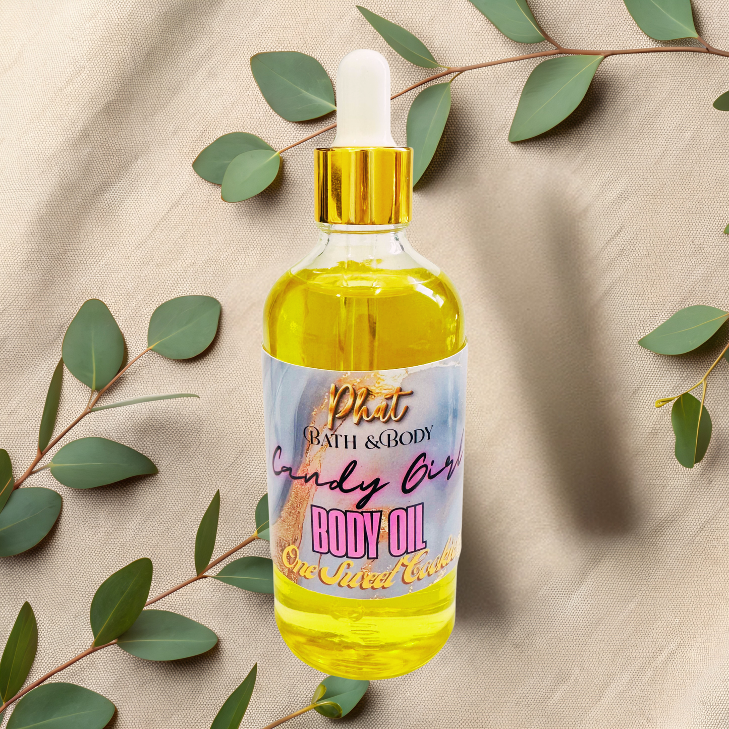 Bottle of body oil with a dropper on a beige fabric background with green leaves.
