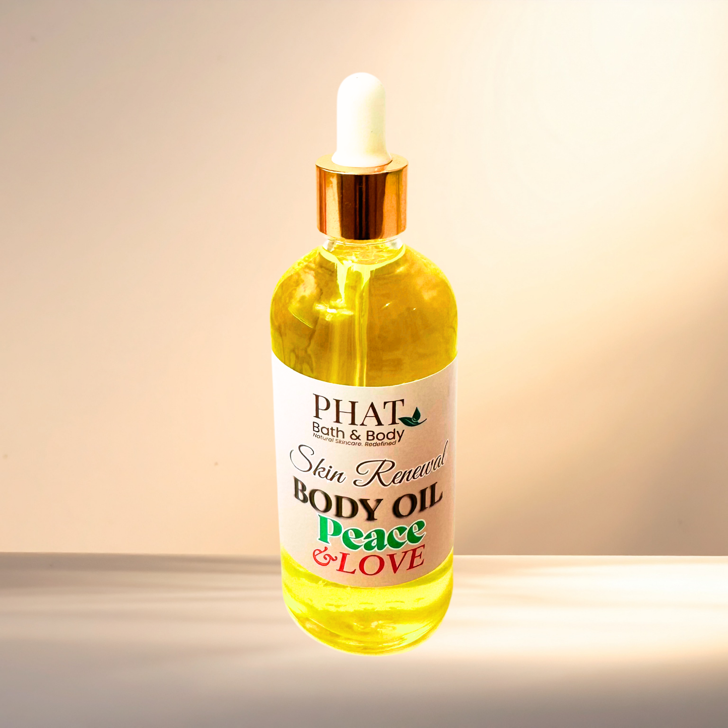 Bottle of PHAT Bath & Body body oil with a dropper on a gradient background