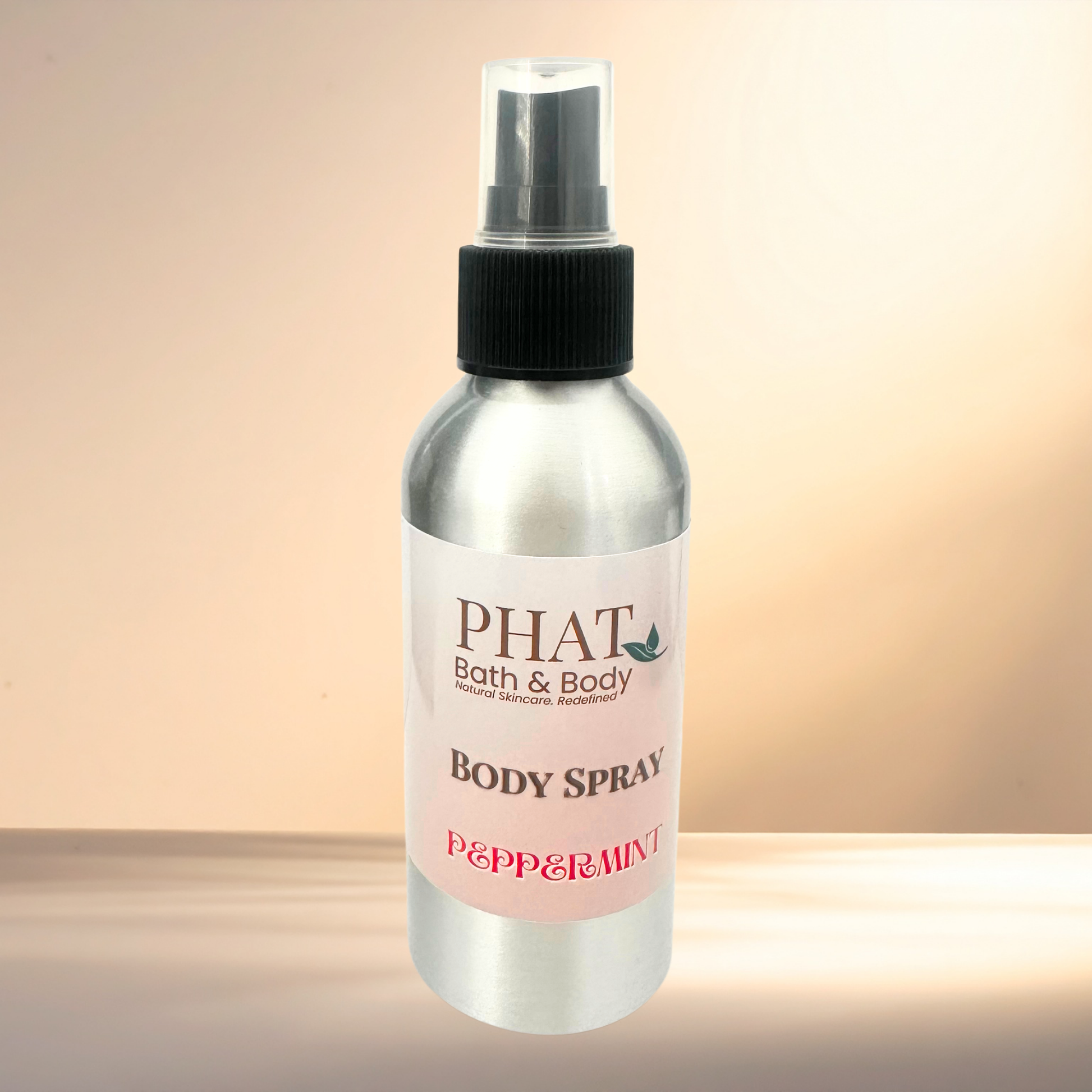 Body spray bottle with 'PHAT Bath & Body' label on a gradient background