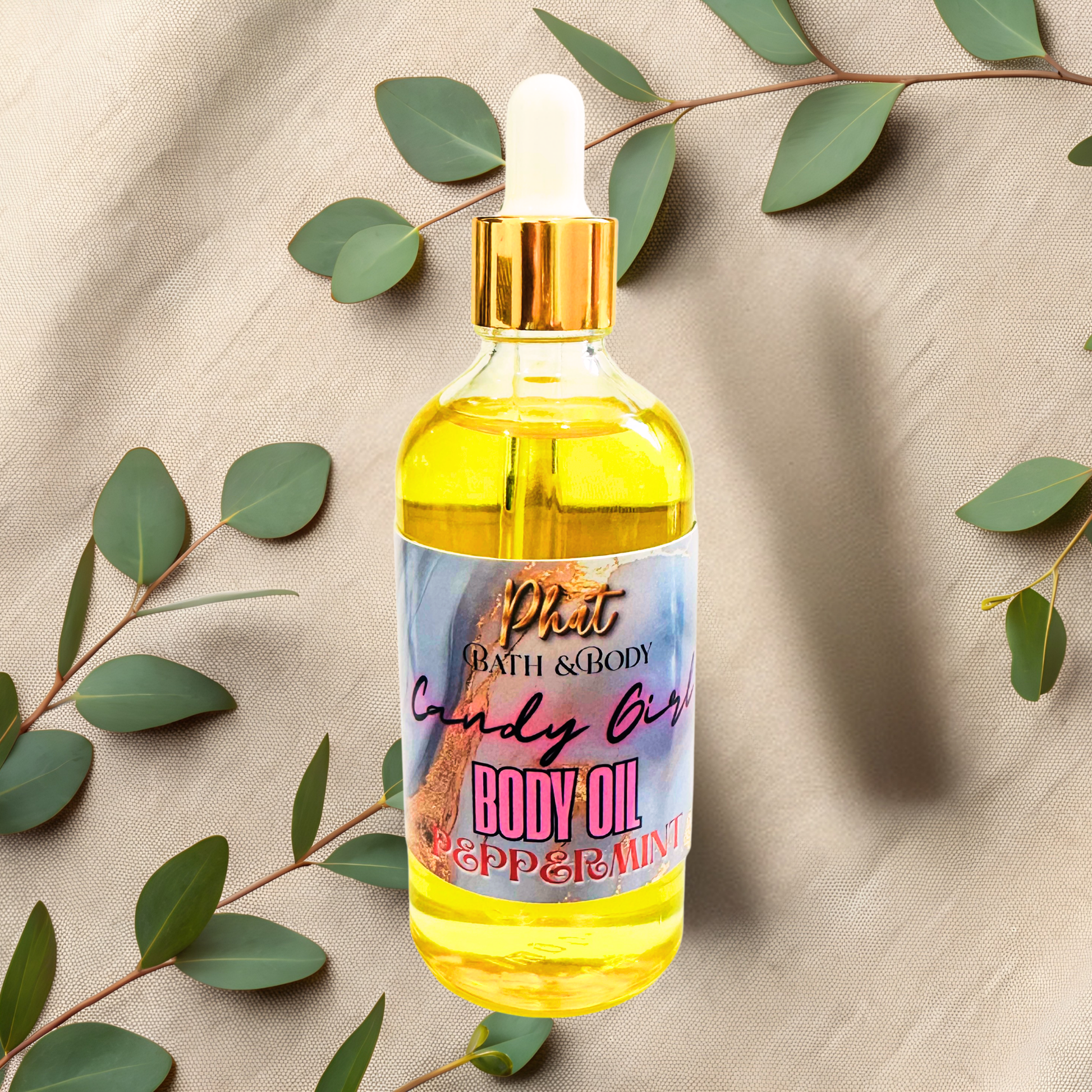 Bottle of body oil with a dropper on a beige fabric background with green leaves.