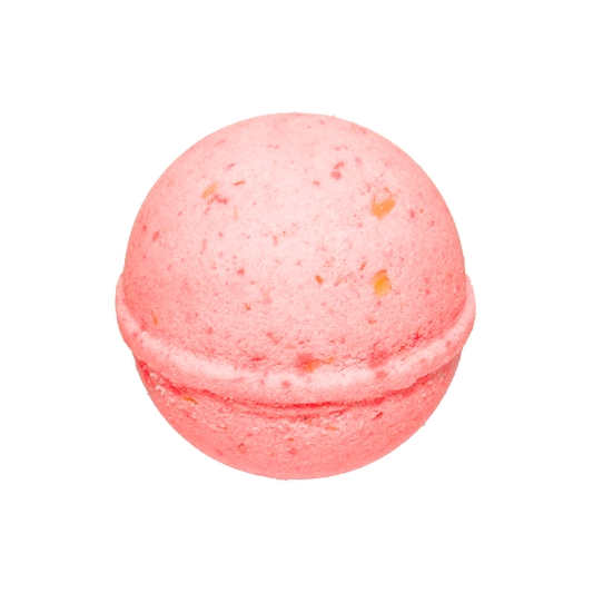 Pink bath bomb with speckles on a white background