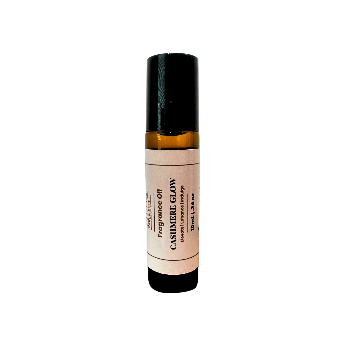 An amber glass rollerball bottle of Cashmere Glow Fragrance Oil with a cream label and black cap, centered on a plain white background.