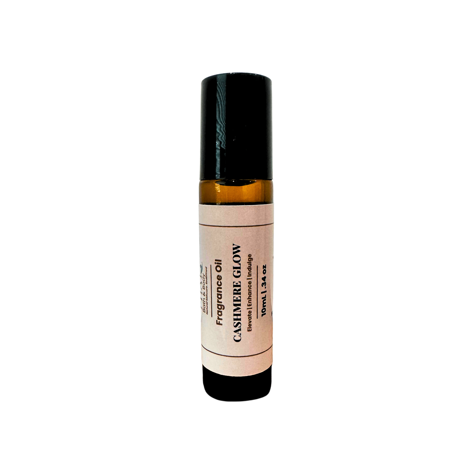 An amber glass rollerball bottle of Cashmere Glow Fragrance Oil with a cream label and black cap, centered on a plain white background.